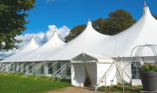 a row of blue portable restrooms waiting to be used at a special event in Hobart